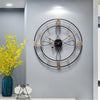 large industrial wall clock with black metal frame and gold roman numerals for vintage modern home decor